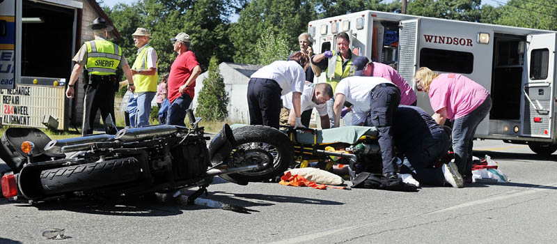 Medics attend to a man who was injured Monday morning after falling off a motorcycle on Route 17 in Windsor. The victim was flown by helicopter to a hospital for treatment.