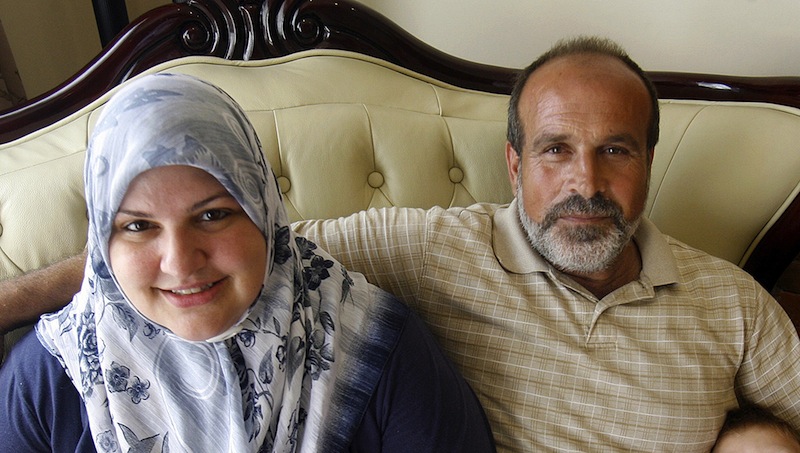 In this 2009 photo, Abdulrahman Zeitoun and his wife, Kathy, pose for a photo in their Broadmoor home in New Orleans. Abdulrahman Zeitoun, who paddled his canoe through the eerily quiet flooded landscape of New Orleans helping people and animals after Hurricane Katrina, has been accused of trying to hire someone to murder his now ex-wife, her son and another man. (AP Photo/The Times-Picayune, Michael DeMocker)