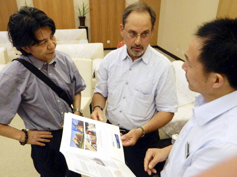 University of Maine at Augusta Professor Robert Katz, center, with interpreter, left, and, the vice director of the Memorial Hall of the Victims in Nanjing Massacre by Japanese Invaders present educational materials developed by the Holocaust and Human Rights Center of Maine.