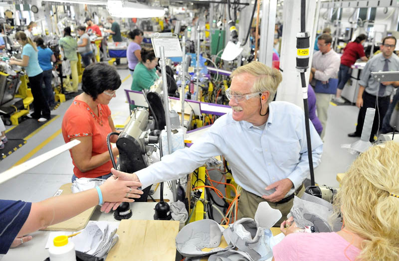 Angus King, center right, shakes hands with New Balance employees during a campaign tour of the Skowhegan factory Tuesday.