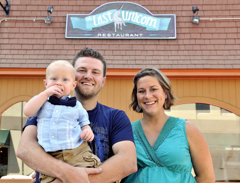 FAMILY BUSINESS: Fred and Amy Ouellette with their son Fred, Jr., stand outside the Last Unicorn in Waterville on Thursday. The Ouellettes plan to open the doors at The Last Unicorn for business in September.