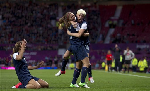 United States' Megan Rapinoe, right, celebrates with teammate Alex Morgan as Tobin Heath slides in on her knees after scoring against Canada during their semifinal women's soccer match at the 2012 London Summer Olympics, Monday, Aug. 6, 2012, at Old Trafford Stadium in Manchester, England. (AP Photo/Jon Super) 2012 London Olympic Games