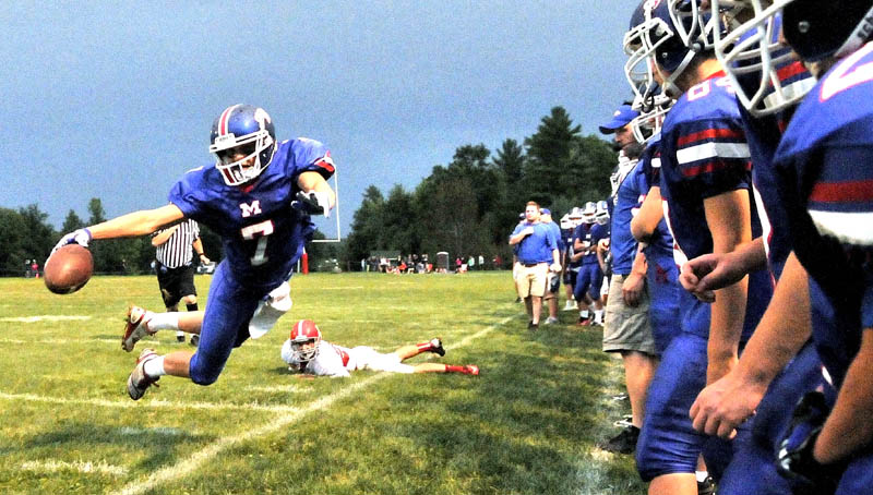 Messalonskee High School's Jake Dexter, 7, dives for a first down in the first quarter against Cony High School at Messalonskee High School in Oakland.