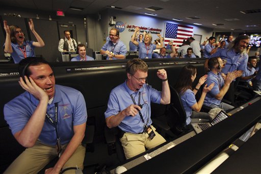 Peter Ilott, center, and his colleagues celebrate a successful landing inside the Spaceflight Operations Facility for NASA's Mars Science Laboratory Curiosity rover at Jet Propulsion Laboratory in Pasadena, Calif. on Sunday. The Associated Press photo