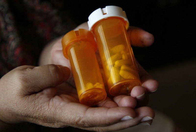Sandra Pico, 52, holds medications she takes, at her home in North Miami Beach, Fla., Thursday, July 26, 2012. Pico makes about $15,000 a year working about 20 hours a week as a home health aide, a bit too much to qualify for Medicaid, but not enough that she can afford private insurance. She thought she'd be getting health insurance after the Supreme Court upheld the health care law. Then she learned her own governor won't agree to expand Medicaid under the law which would have given her coverage. (AP Photo/Lynne Sladky)
