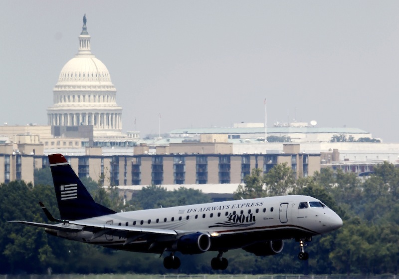 With the Capitol in the background, a US Airways airplane makes its final approach at Ronald Reagan Washington National Airport, Thursday, Aug. 2, 2012. Transportation Secretary Ray LaHood said Thursday that none of the three commuter jets that flew to close together near Washington was ever on course to collide head-on with the others. (AP Photo/Haraz N. Ghanbari)