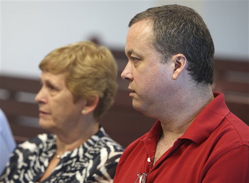 Mark Kerrigan, brother of ice skater Nancy Kerrigan, sits with his mother, Brenda Kerrigan, left, during a hearing at Middlesex Superior Court in Woburn, Mass., today.
