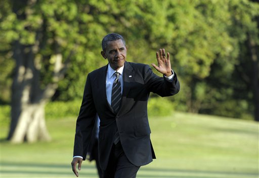 President Barack Obama waves as he walks from Marine One on the South Lawn of the White House in Washington on Wednesday after returning from campaigning.