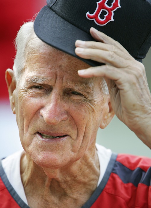 In this Aug. 31, 2006, file photo, Boston Red Sox great Johnny Pesky lifts his cap during a television interview before a baseball game against the Toronto Blue Jays in Boston. Pesky, who spent most of his 60-plus years in pro baseball with the Red Sox and was beloved by the team's fans, has died on Monday, Aug. 13, 2012, in Danvers, Mass. He was 92. (AP Photo/Michael Dwyer, File)
