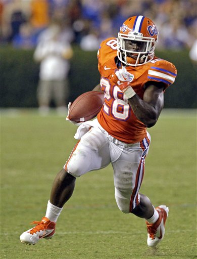 In this Sept. 3, 2011, photo, Florida running back Jeff Demps carries against Florida Atlantic during an NCAA college football game in Gainesville, Fla. The New England Patriots have reportedly agreed to terms with Olympic silver medalist Demps, who played at Florida but was not drafted by an NFL team. Multiple reports said Demps had agreed to a deal with the team. (AP Photo/John Raoux) NCAA