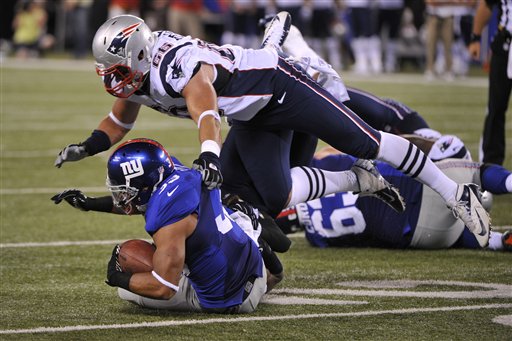 New England Patriots defensive end Jake Bequette (66) tackles New York Giants defensive back Dante Hughes (33) during the second half of a preseason NFL football game Wednesday, Aug. 29, 2012, in East Rutherford, N.J. The Giants won the game 6-3. (AP Photo/Bill Kostroun)