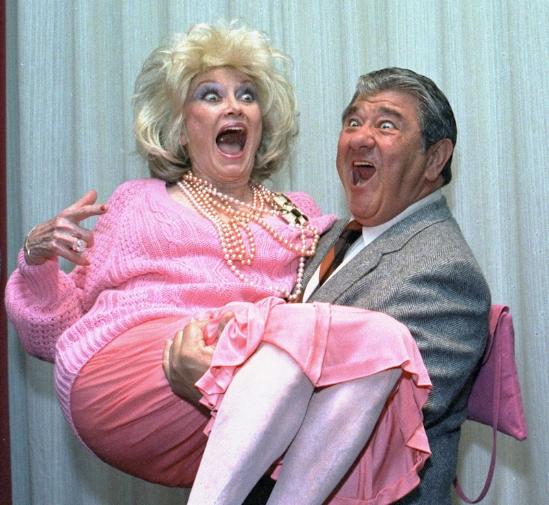 In this Oct. 9, 1985, file photo, Comedian Phyllis Diller gets a lift from emcee Buddy Hackett prior to the celebrity stag luncheon roast at the New York Friars Club in New York City. Diller, the housewife turned humorist who aimed some of her sharpest barbs at herself, died Monday, Aug. 20, 2012, at age 95 in Los Angeles. (AP Photo/Marty Lederhandler, File)