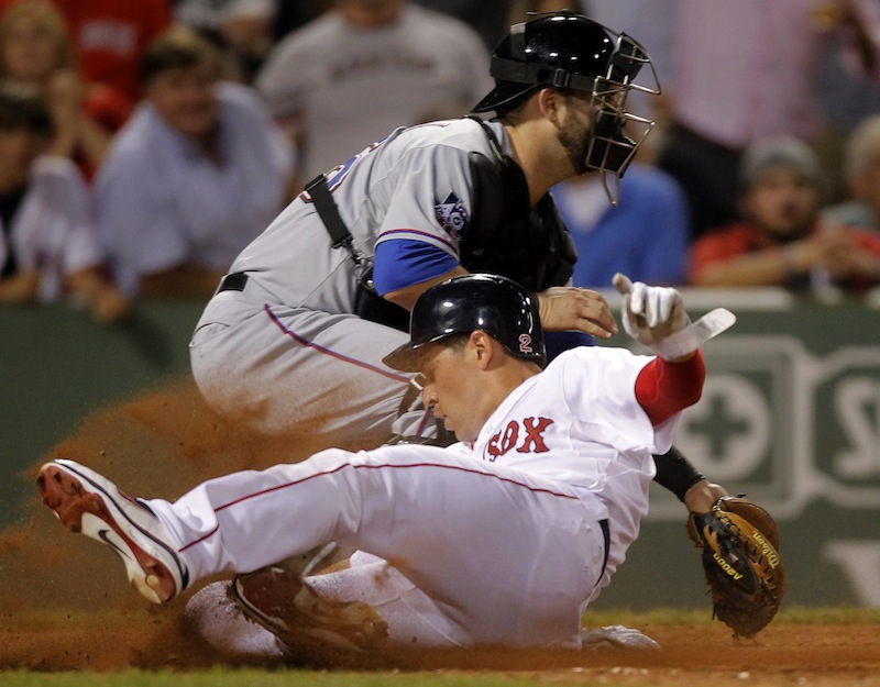 Boston Red Sox's Jacoby Ellsbury, front, scores on a double hit by Red Sox's Carl Crawford as Texas Rangers catcher Mike Napoli, behind, waits for the ball in the eighth inning of a baseball game at Fenway Park, in Boston, Monday, Aug. 6, 2012. (AP Photo/Steven Senne)