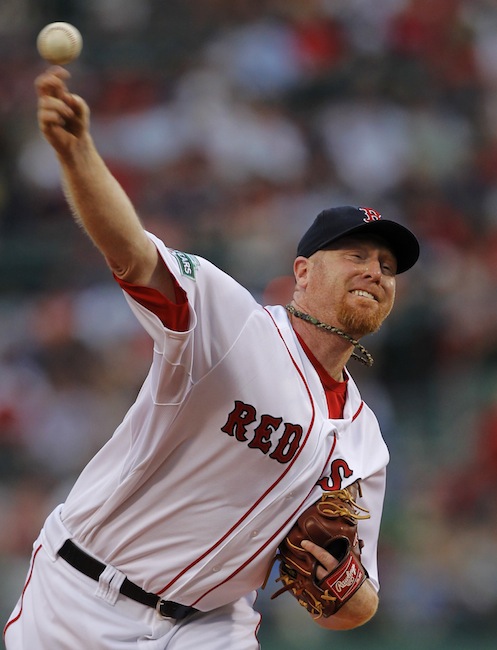 Boston Red Sox's Aaron Cook delivers a pitch against the Texas Rangers in the first inning of a baseball game at Fenway Park, in Boston, Monday, Aug. 6, 2012. (AP Photo/Steven Senne)