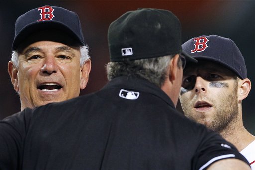 Boston Red Sox manager Bobby Valentine, left, and Boston's Dustin Pedroia, right, argue with first base umpire Paul Nauert in the ninth inning of a baseball game against the Texas Rangers in Boston, Tuesday, Aug. 7, 2012. Pedroia was ejected. The Rangers won 6-3. (AP Photo/Michael Dwyer)