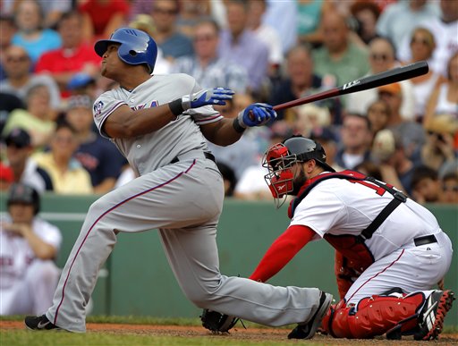Texas Rangers' Adrian Beltre, left, hits a sacrifice fly off a pitch by Boston Red Sox's Alfredo Aceves, allowing Rangers' Elvis Andrus to score, in the ninth inning of a baseball game at Fenway Park in Boston, Wednesday, Aug. 8, 2012. The Rangers won 10-9. Red Sox catcher Kelly Shoppach, right, looks on. (AP Photo/Steven Senne)