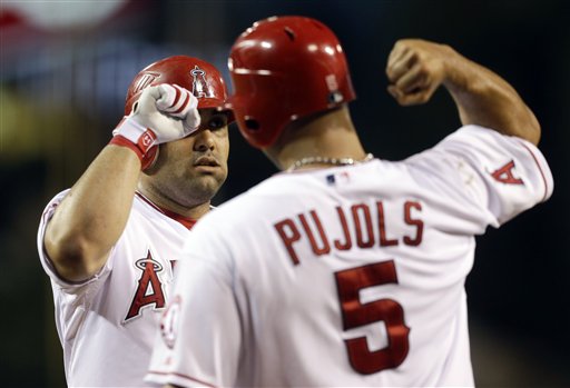 Los Angeles Angels' Kendrys Morales celebrates his two run home run with Albert Pujols (5) during first inning of an baseball against the Boston Red Sox in Anaheim, Calif., Wednesday, Aug. 29, 2012. (AP Photo/Chris Carlson)