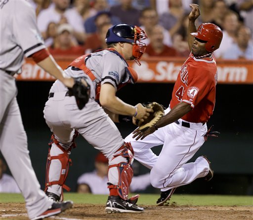 Los Angeles Angels' Torii Hunter, right, scores past Boston Red Sox catcher Ryan Lavarnway on a single by Mark Trumbo during the third inning of an baseball in Anaheim, Calif., Thursday, Aug. 30, 2012. (AP Photo/Chris Carlson)