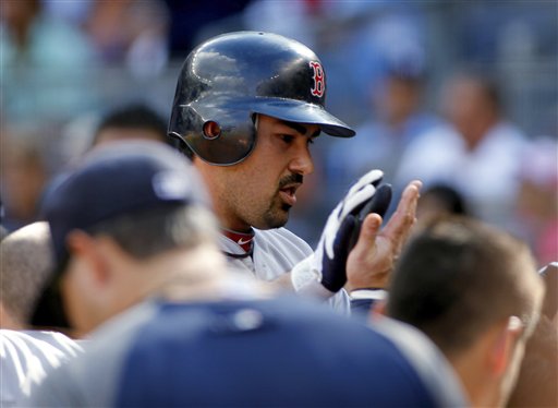 Boston Red Sox's Adrian Gonzalez is congratulated as he returns to the dugout after hitting a two-run home run off of New York Yankees' David Phelps in the first inning of a baseball game Saturday, Aug. 18, 2012, at Yankee Stadium in New York. (AP Photo/John Dunn)
