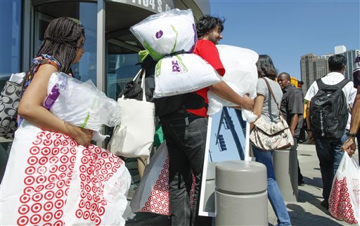 Shoppers carry their purchases at a Target in Chicago. Americans kept spending in August despite their escalating fears about the slow economic recovery and surging gas prices.