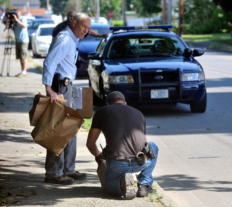 Waterville Police and Maine State Police collect evidence after they apprehended two suspects on Pleasant Street in Waterville in connection to a Rite Aid robbery this morning.