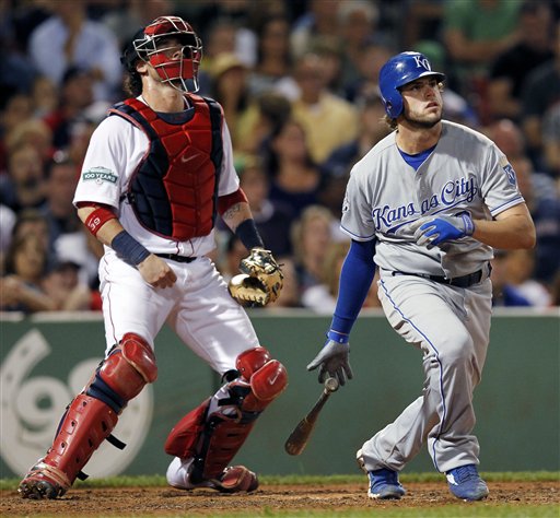 Kansas City Royals' Mike Moustakas, right, watches his two-run triple in front of Boston Red Sox's Jarrod Saltalamacchia in the seventh inning of a baseball game in Boston, Saturday.
