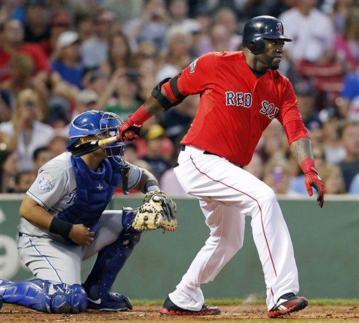 Boston Red Sox's David Ortiz, right, follows through on a two-run single in front of Kansas City Royals' Brayan Pena in the first inning of a baseball game in Boston, Friday.