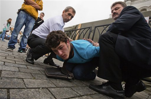 An unidentified supporter of Pussy Riot is detained by Christ the Saviour Cathedral security in Moscow on Wednesday.