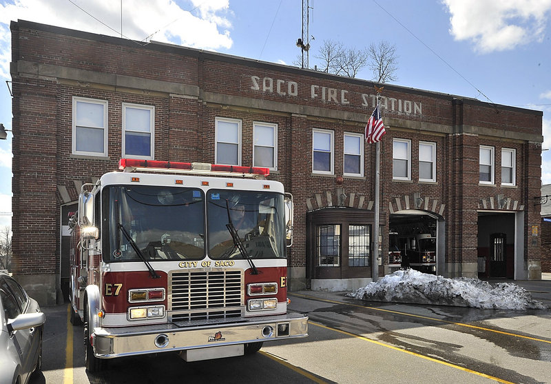A Saco firefighter backs a truck into the Central Fire Station on the last day of its occupancy in 2011.