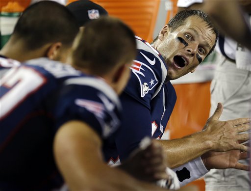 New England Patriots quarterback Tom Brady, right, talks with teammates on the bench in the second quarter of an NFL preseason football game against the New Orleans Saints in Foxborough, Mass. Thursday, Aug. 9, 2012.