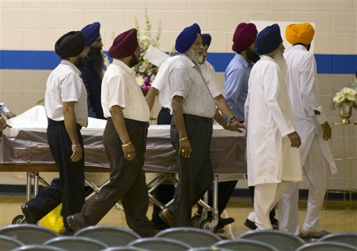 Sikh temple members bring in a casket for the funeral and memorial service for the six victims of the Sikh Temple of Wisconsin mass shooting in Oak Creek, Wis., today.