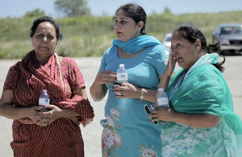 Women who said they family members were in the Sikh temple in Oak Creek, Wis., wait for information after a shooting there Sunday morning. Seven people were killed, including the shooting suspect.