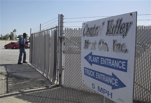 A security guard opens the gate at the Central Valley Meat Co., the California slaughterhouse shut down by federal regulators after they received video showing cows being repeatedly shocked and shot before being slaughtered.