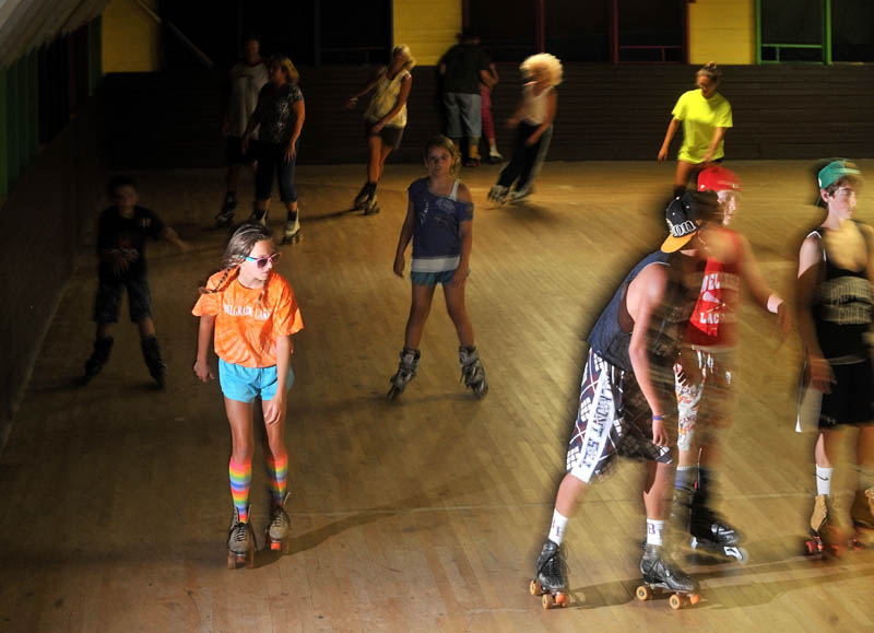 Staff Photo by Michael G. Seamans Dressed for the part in her rainbow knee-high socks and sunglasses, Brycie Bowser, 11, of Natic, Mass., roller skates with friends and family at Sunbeam Roller Rink in Smithfield on Friday, Aug. 8, 2012. The Sunbeam Roller Rink has become a landmark in Smithfield having served the roller skating needs of the since it was built in 1922.