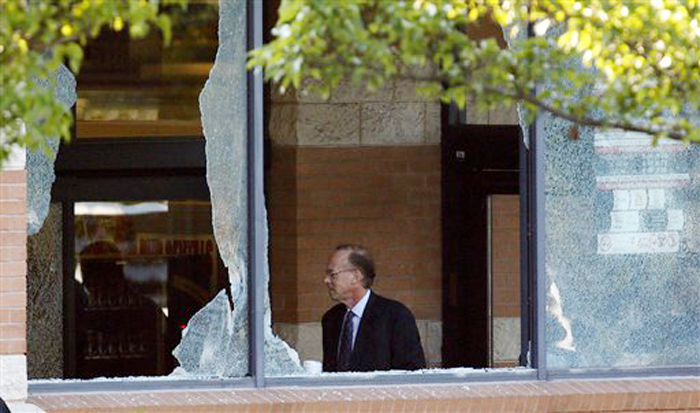 Middlesex County prosecutor Bruce Kaplan is seen through two broken windows as he arrives at the scene of a shooting at a Pathmark grocery store in Old Bridge, N.J., Friday.
