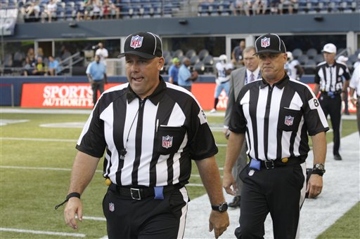 Replacement officials take the field at the start of an NFL football preseason game between the Seattle Seahawks and the Tennessee Titans last Saturday in Seattle.