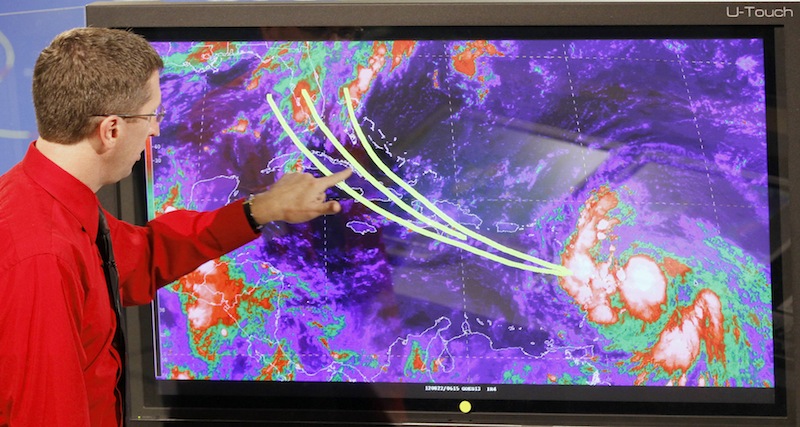 Dr. Rick Knabb, director of the National Hurricane Center, shows some of the possible trajectories tropical storm Isaac could develop in the coming days, Wednesday, Aug. 22, 2012, at the National Hurricane Center in Miami. As of 11:00 AM tropical storm Isaac's location 15.9 degrees north, 59.3 degrees west, about 140 miles east of Guadeloupe, maximum sustained winds 45 mph, present movement west or 280 degrees at 21 mph. (AP Photo/Alan Diaz)
