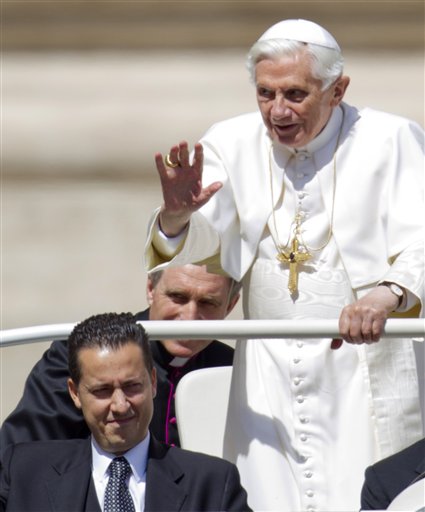 Pope Benedict XVI delivers his blessing as he arrives at St. Peter's square at the Vatican for a general audience in this May, 23, 2012, photo. His personal butler Paolo Gabriele is at lower left.