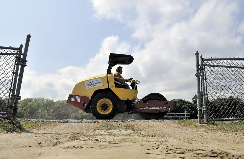 Tony Rossignol compacts the track at Winslow High School during a reconstruction project to renovate the track surface on Thursday.