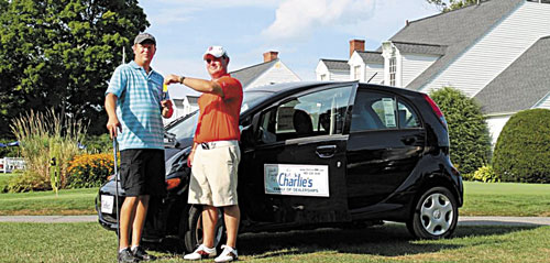 HERE’S YOUR KEYS: Mike DuBois of Benton, left, poses with Steve Shuman of Charlie’s Motor Mall after DuBois won an electric car in a tournament last week at the Augusta Country Club in Manchester.