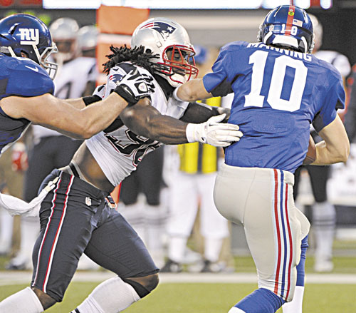 TAKEDOWN: New England Patriots linebacker Jermaine Cunningham sacks New York Giants quarterback Eli Manning during a preseason game Wednesday in East Rutherford, N.J. Cunningham helped his chances of making the Patriots roster with a strong preseason.
