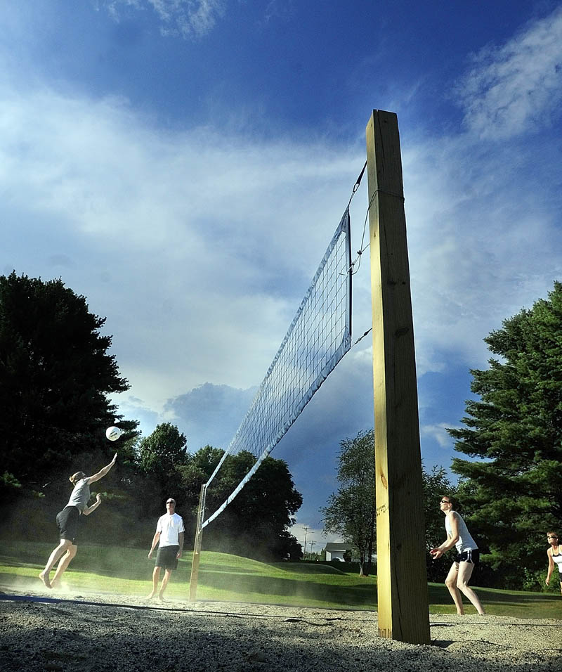 Players hit the ball during a practice session on Friday evening at the new beach volleyball court at Youth Memorial Park in Augusta. The courts are behind the Buker Center near the corner of Capital Street and Alden Avenue.