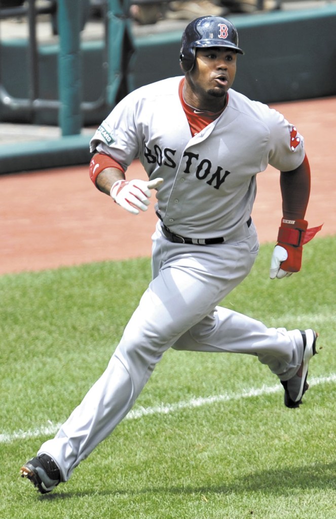 On the run: Boston’s Carl Crawford rounds third base while scoring on a double by Dustin Pedroia during the Red Sox’ 14-1 win over the Cleveland Indians on Sunday in Cleveland.