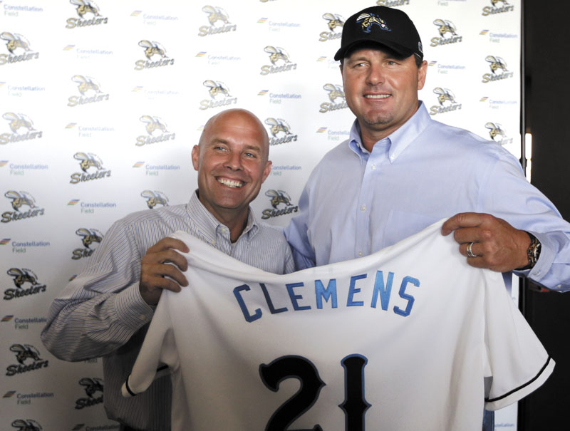 Roger Clemens, right, smiles along with team president Matt O'Brien, left, while posing for photographers after a news conference officially announcing his signing with the Sugar Land Skeeters baseball team Tuesday, Aug. 21, 2012, in Sugar Land, Texas. Clemens, a seven-time Cy Young Award winner, signed with the Skeeters of the independent Atlantic League on Monday and is expected to start for the minor league team on Saturday at home against Bridgeport. (AP Photo/David J. Phillip)
