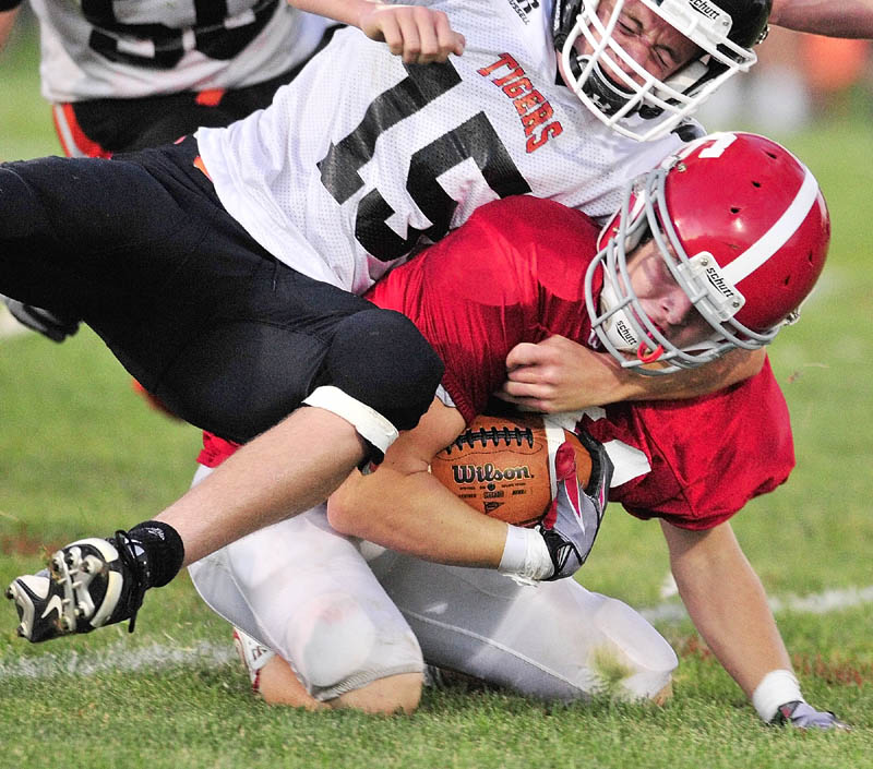 TOUGH TACKLE: Gardiner’s Justin Lovely tackles Cony’s Brandon St. Michel during last year's 134th Cony-Gardiner football game at Alumni Field in Augusta. The teams kick off their seasons this Friday night.