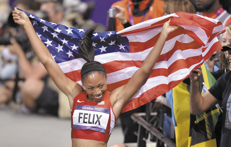 ALL SMILES: Allyson Felix of the United States celebrates her win in the women’s 200-meter final Wednesday in the Olympic Stadium in London. 2012 London Olympic Games Summe