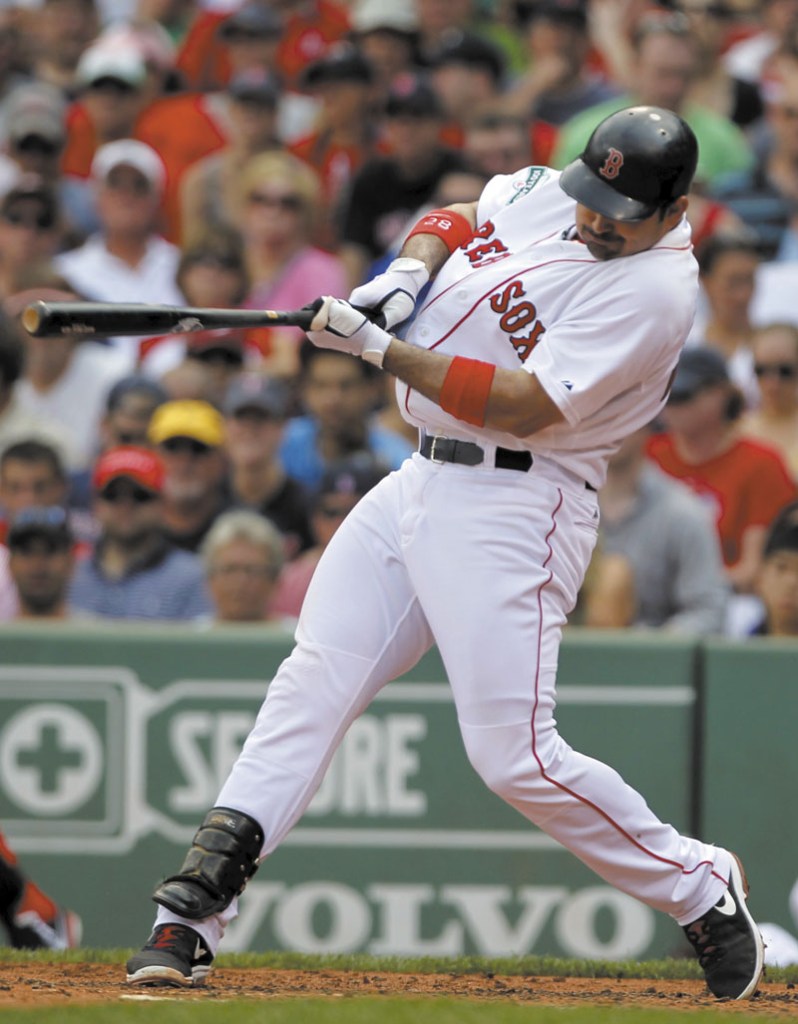 GETTING IT DONE: Boston’s Adrian Gonzalez hits an RBI single in the third inning of the Red Sox’ 6-4 win over the Minnesota Twins on Sunday at Fenway Park, in Boston.