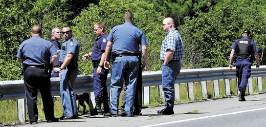 Law enforcement officers from several agencies prepare to spread out along Route 150 in Skowhegan in an effort to capture escaped Somerset County Jail inmate Dylan Perkins. The area searched by officers, a tracking dog and an airplane concentrated in the woods between Route 150 and the Steward Hill Road.