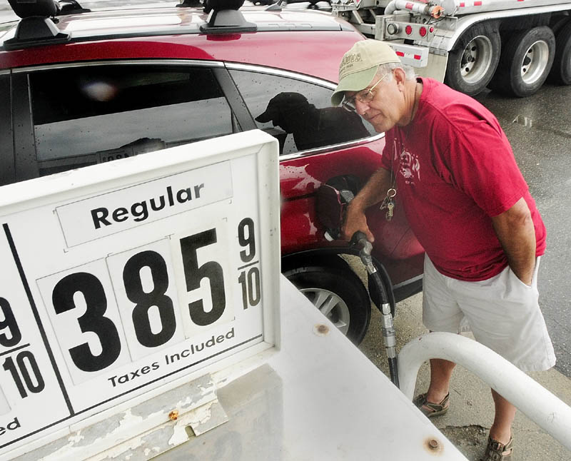 Joe Wutka fills up his gas tank on Friday afternoon at Zoom In on State Street in Augusta.