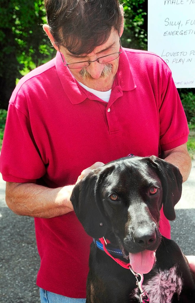 Ralph Rollins pets Balsamic at the Kennebec Valley Humane Society's Empty the Shelter adoption event Saturday in Augusta.